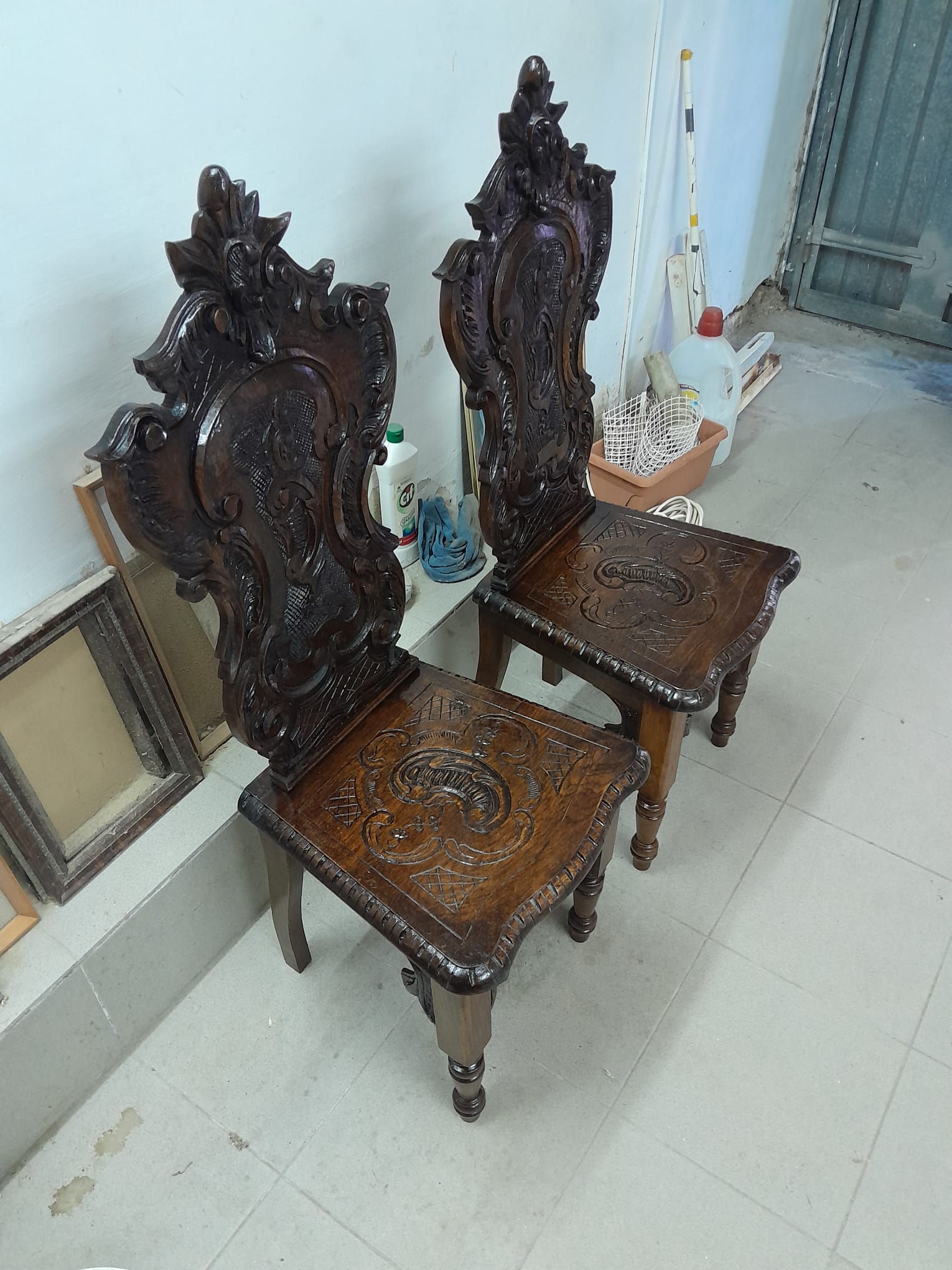 Pair of carved wooden high-back chairs
