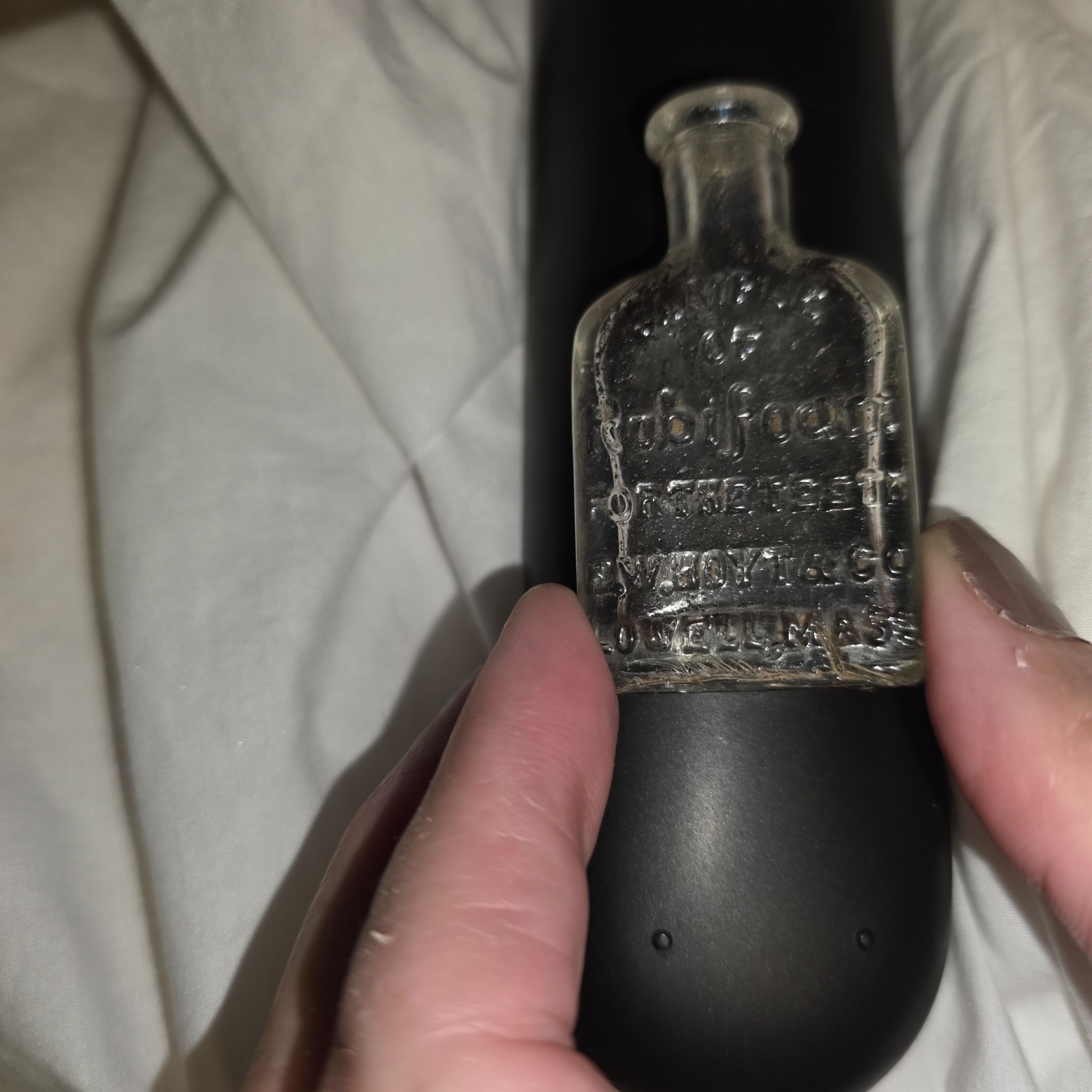Embossed glass medicine bottle (likely patent medicine or pharmacy bottle)