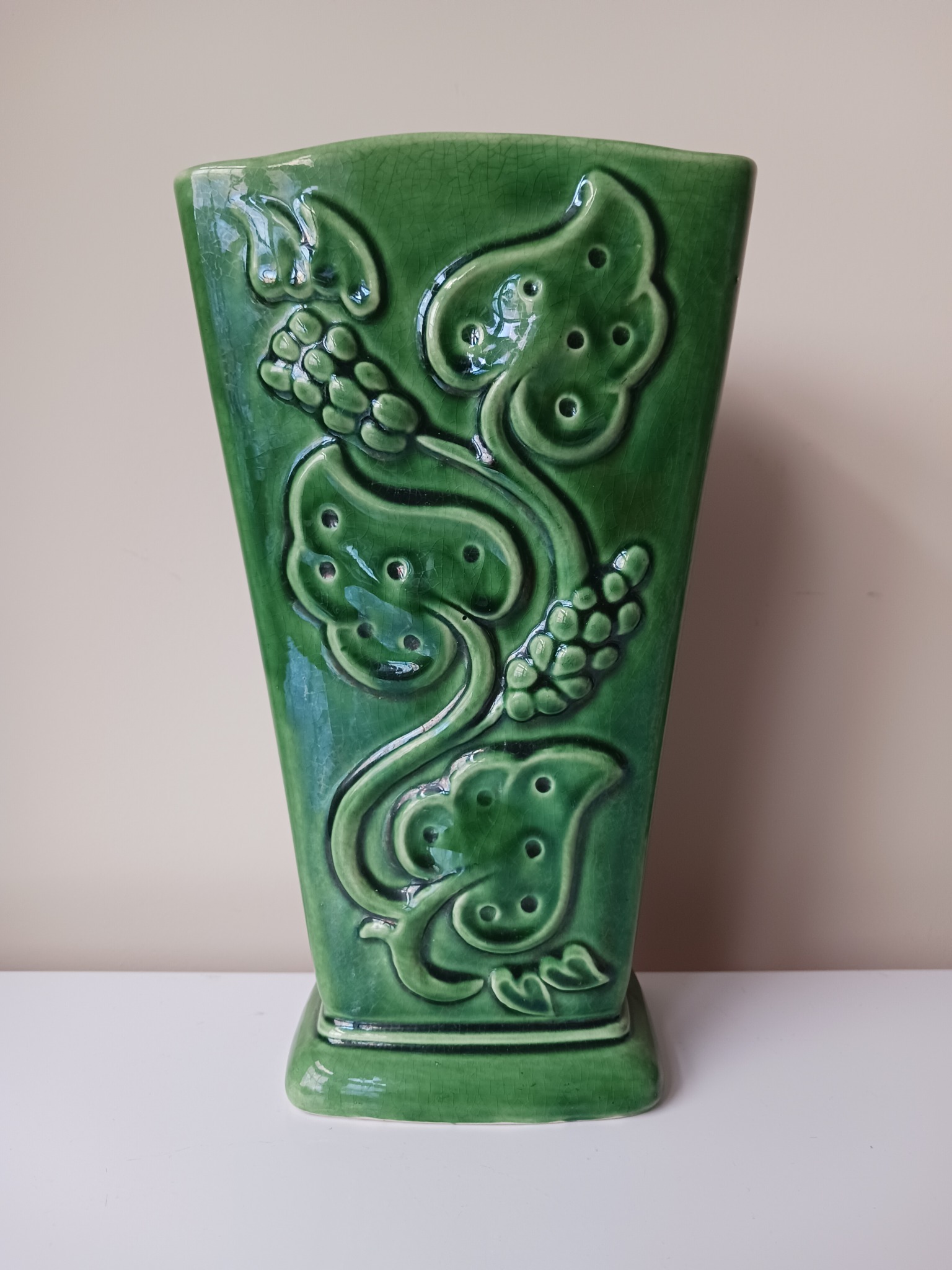 Green glazed ceramic vase with applied grape and vine relief
