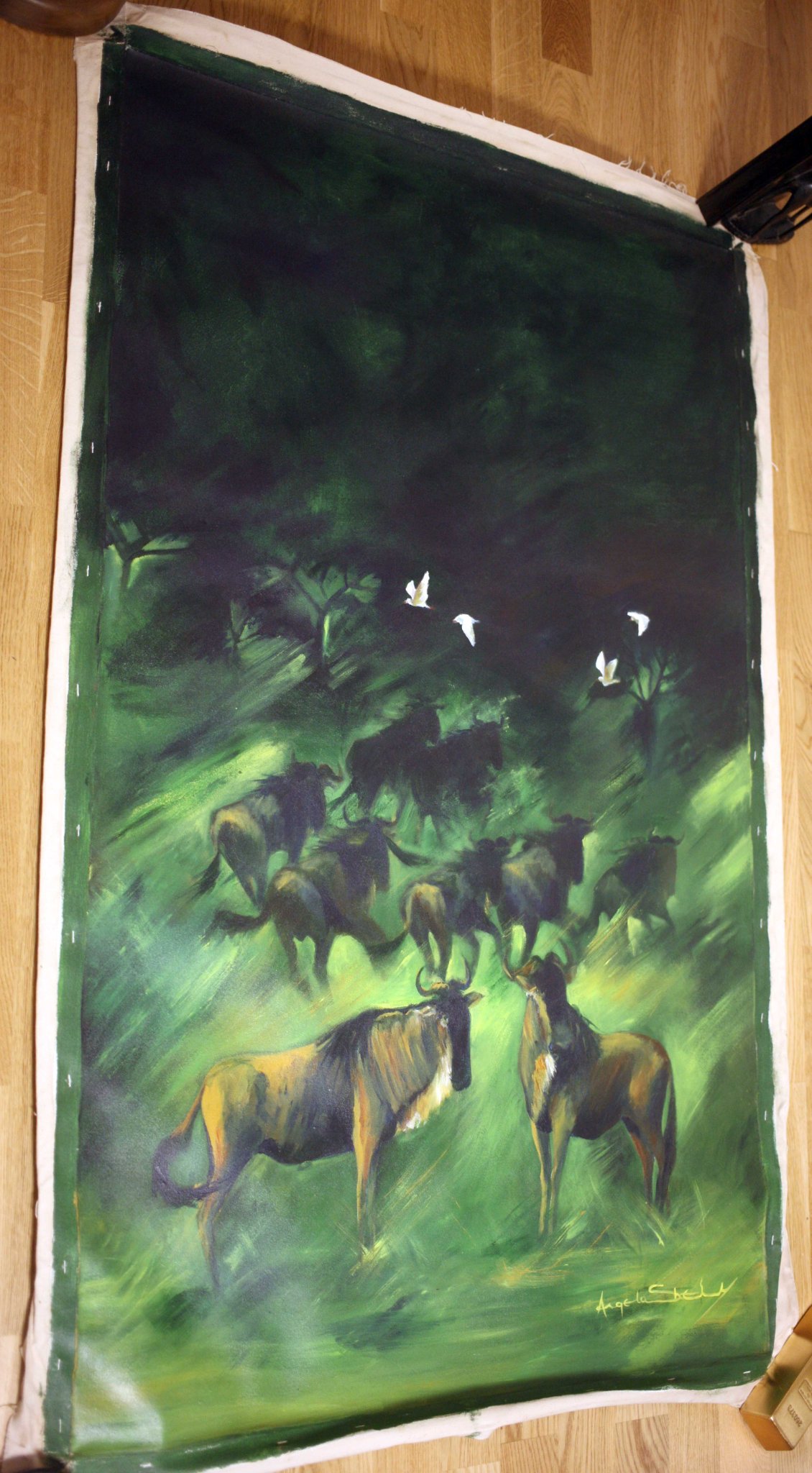 Signed figurative landscape painting depicting cattle at night