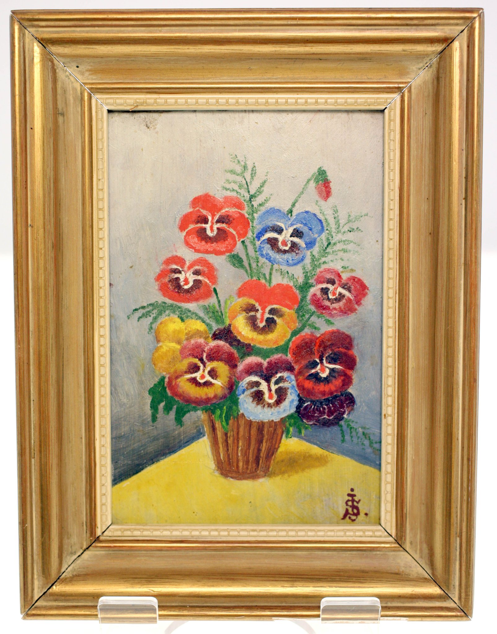 Framed floral still life painting of pansies in a vase