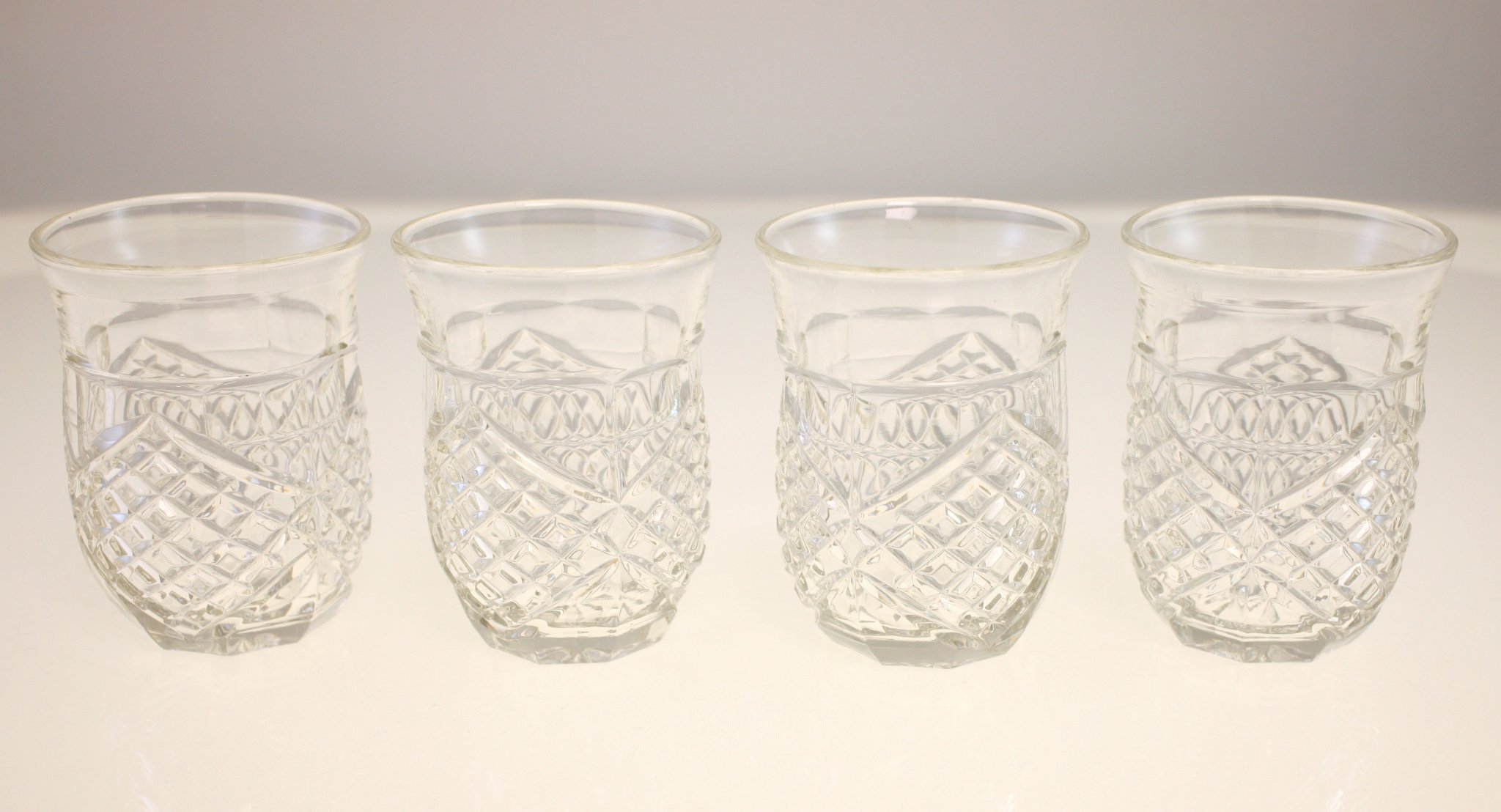 Set of four pressed glass tumblers / drinking glasses