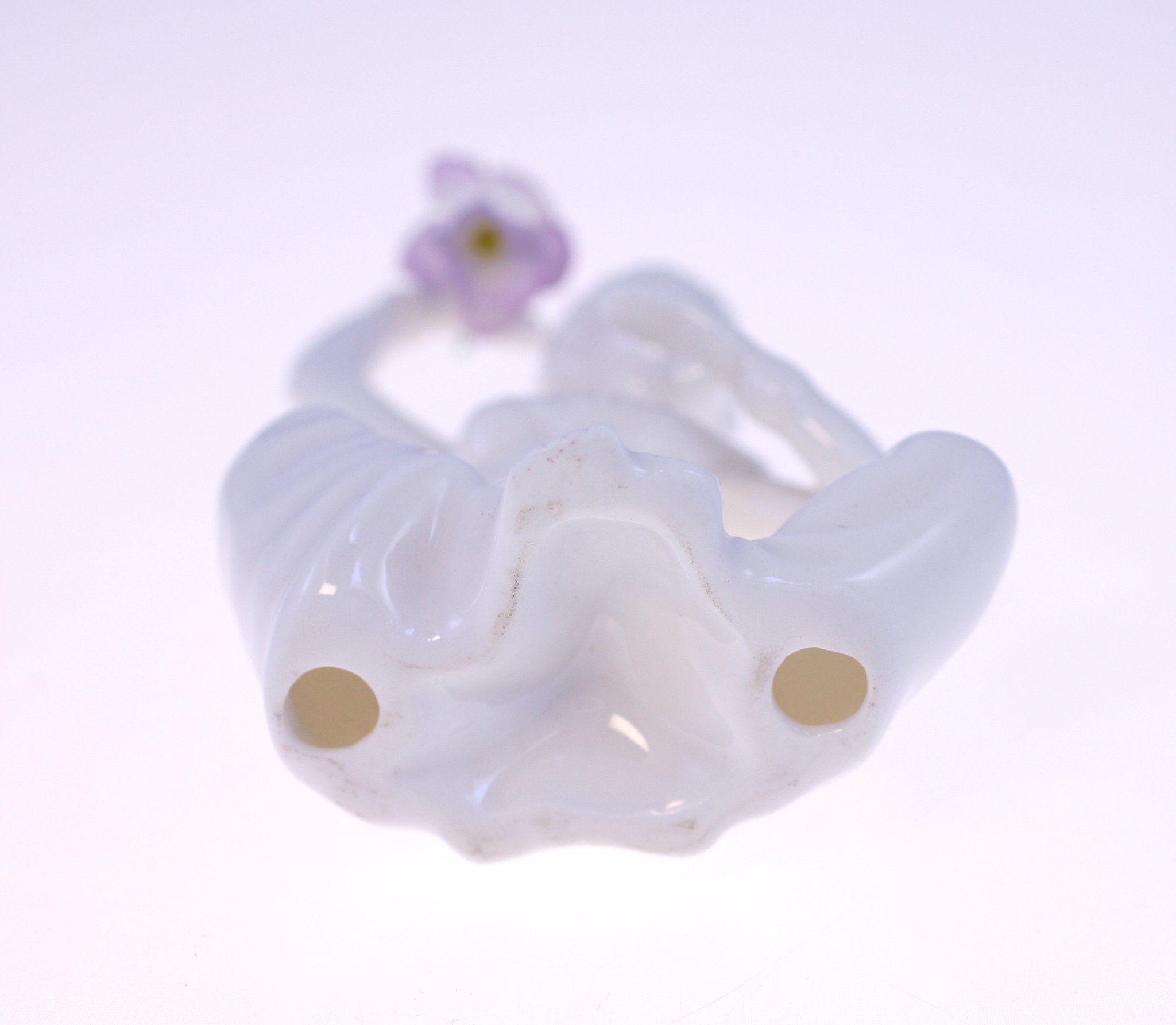 Small porcelain figurine or decorative animal/flower ornament