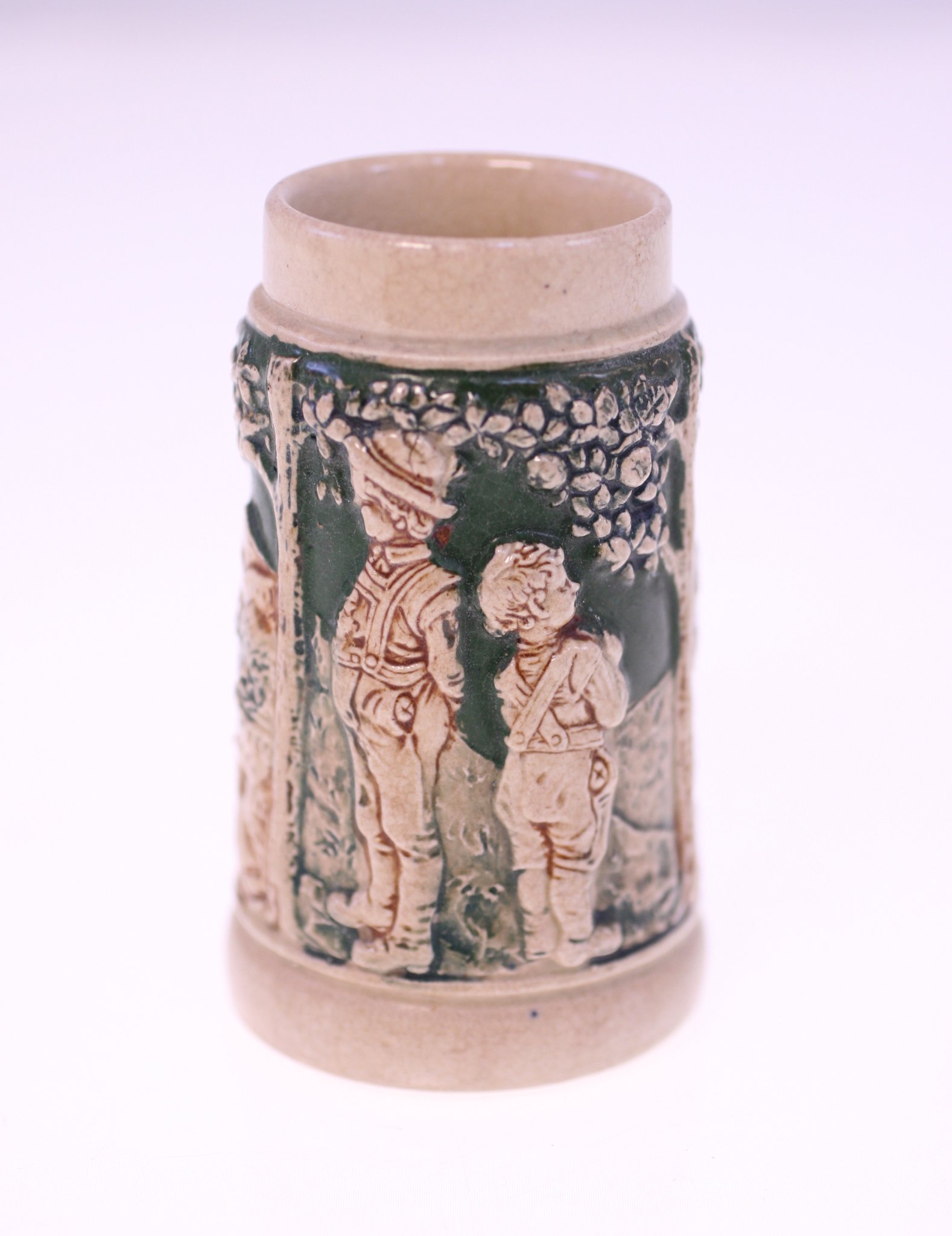 Decorative ceramic tankard or mug with relief figural scene