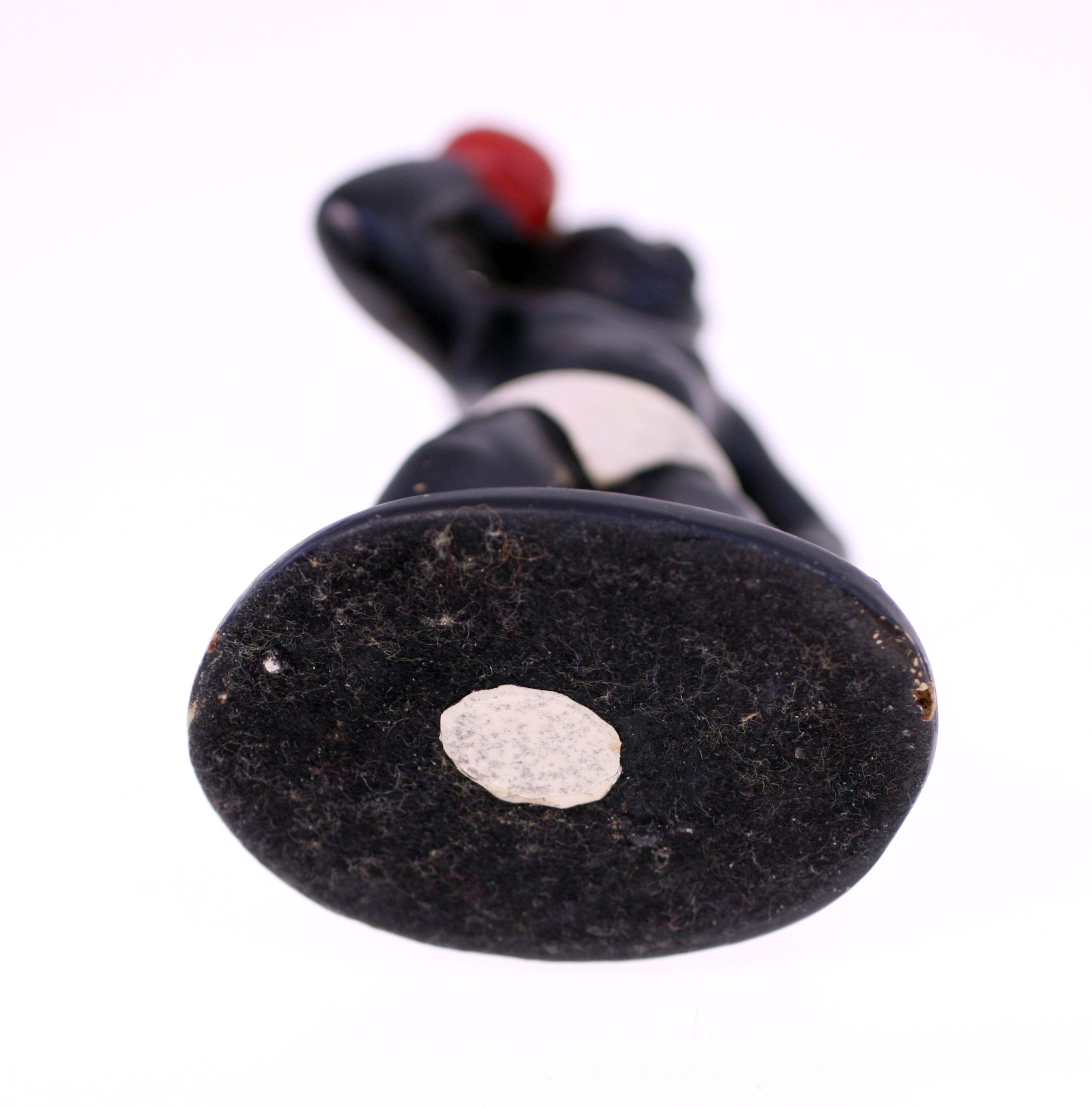 Small carved figurine or doll on a weighted base