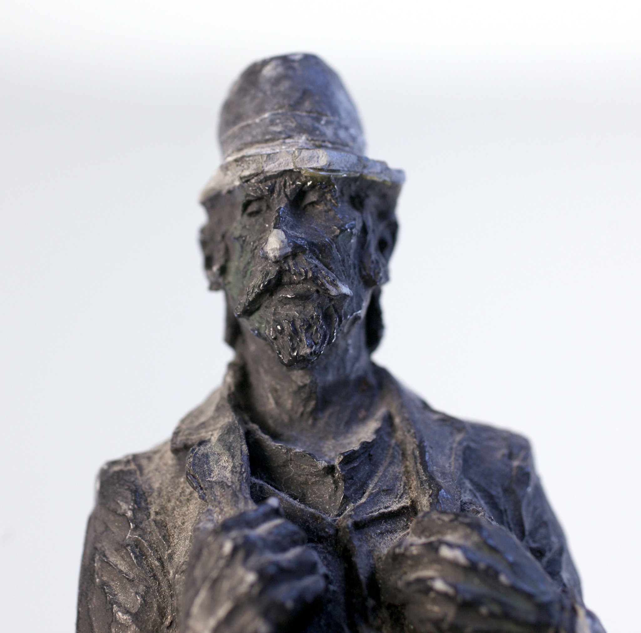 Small carved figurative sculpture of a bearded man