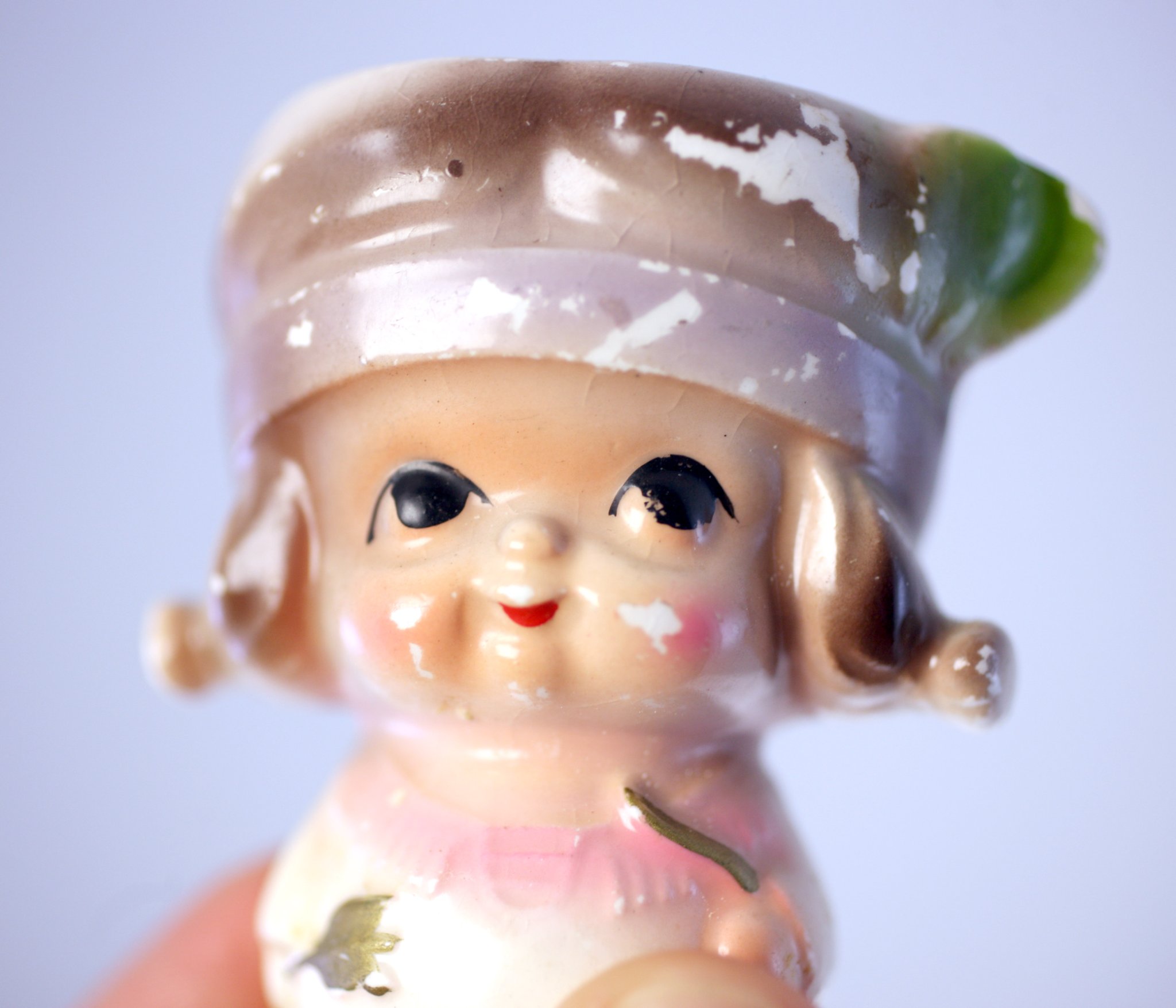 Small ceramic figurine doll, likely a vintage Japanese-style nodder or decorative miniature doll