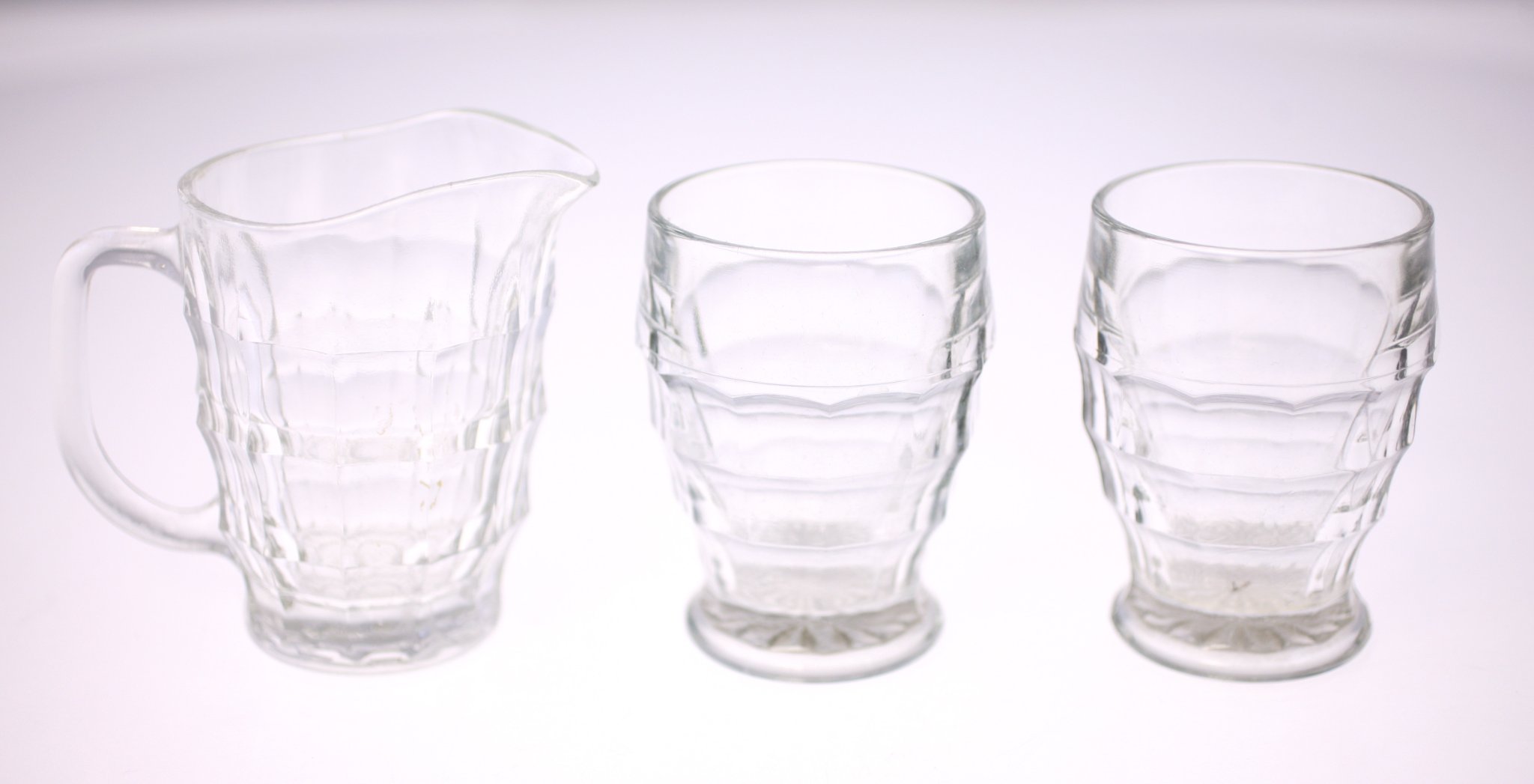 Pressed glass pitcher with matching tumblers