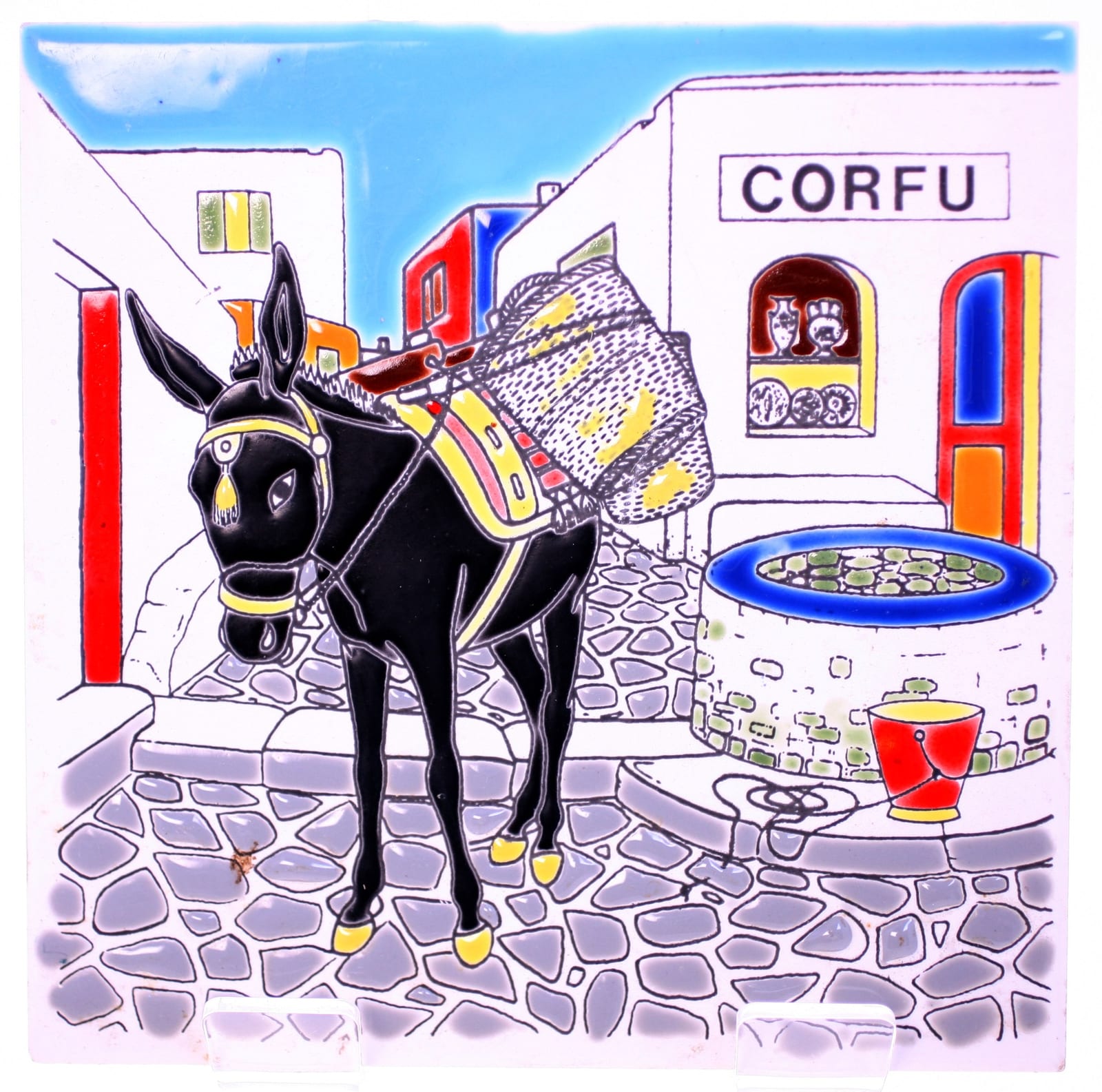 Decorative ceramic tile or plaque depicting a donkey in a Greek island street scene