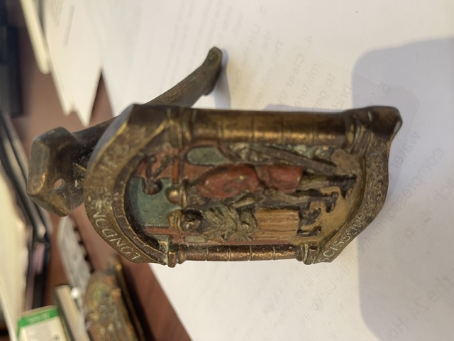 Cast metal decorative door knocker or furniture mount with figural relief