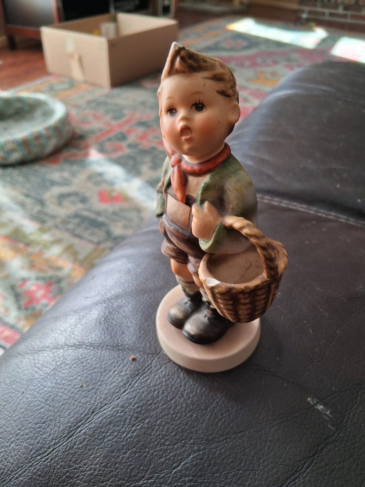 Ceramic/porcelain figurine of a boy with basket