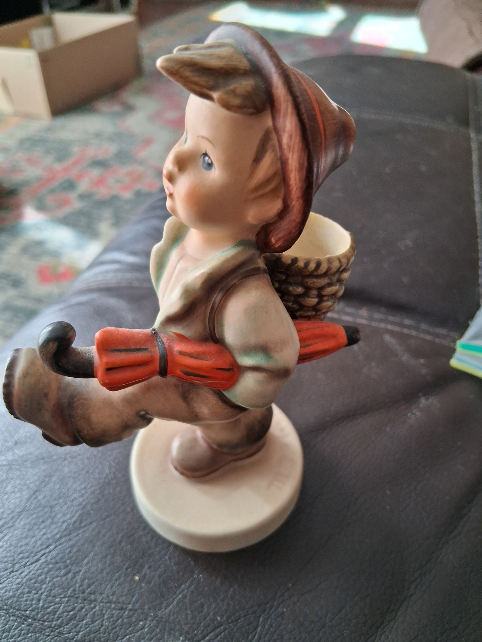 Ceramic figurine of a child in folk costume with basket and hat